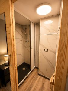 a bathroom with a walk in shower next to a glass door at ZONA NAVIGLI Design Loft , Proiettore schermo 80" in Milan