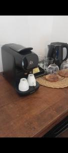 a black coffee maker sitting on a wooden table at Le Garage, La Chambre in Fontevraud-l'Abbaye