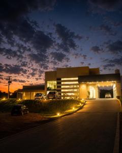 a building with cars parked in front of it at night at Hotel Imperador in Gurupi