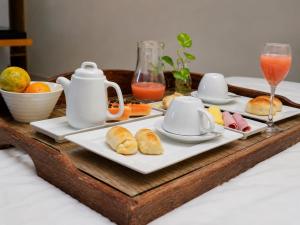 a tray with plates of food on a table at Hotel Imperador in Gurupi