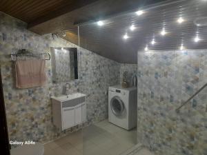 a bathroom with a washing machine and a washer at Miji Stay in Fethiye