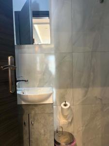 a bathroom with a sink and a mirror at Greysuites in Kavála +29 photos