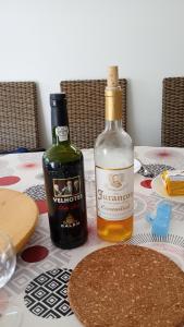 two bottles of wine sitting on top of a table at Chambre chez sylvie in Laruns