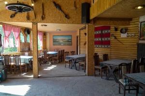 a dining room with tables and chairs in a restaurant at Etno Resort Lipa 