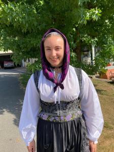 a woman wearing a dress and a head scarf at Chambre chez sylvie in Laruns