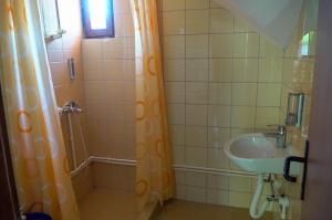 a bathroom with a shower and a sink at Etno Resort Lipa  +52 photos