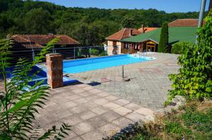 a swimming pool in the backyard of a house at Etno Resort Lipa 
