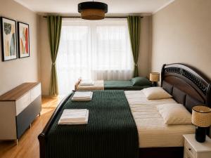 a bedroom with two beds and a window at Nine to Trail Apartment in Wielka Wieś