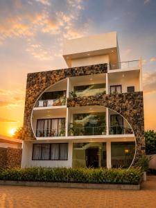 a building with a sunset in the background at Pearl Diamond Resort in Trincomalee