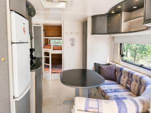 ein Wohnwagen-Wohnzimmer mit Tisch und Sofa in der Unterkunft Quinta Lima in Sertã