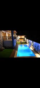 a large swimming pool in the yard of a house at villa serenity in Jarabacoa +7 photos