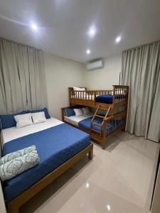 a bedroom with two beds and a bunk bed at villa serenity in Jarabacoa