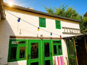 a building with green doors and christmas lights at Casa Ricardo in Svendborg