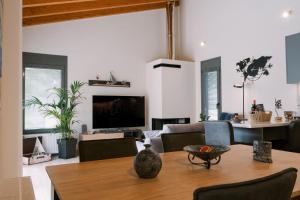 a living room with a couch and a table at Odysseas Seaside Escape by Philoxenia in Artemida