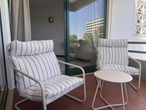 two chairs and a table on a balcony at Vilamoura Marina Beach Apartament in Quarteira