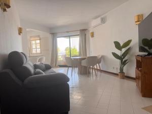 a living room with a couch and a table at Vilamoura Marina Beach Apartament in Quarteira