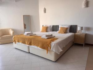 a bedroom with a large bed with a mirror at Vilamoura Marina Beach Apartament in Quarteira