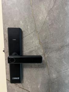 a black door handle on a stone wall at Downtown Apartment, Sierra Nevada 3 in Ibarra