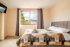 a bedroom with a bed with a teddy bear on it at Downtown Apartment, Sierra Nevada 3 in Ibarra