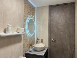 a bathroom with a sink and a mirror at Downtown Apartment, Sierra Nevada 3 in Ibarra +23 photos