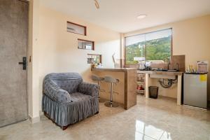 a living room with a chair and a desk at Downtown Apartment, Sierra Nevada 3 in Ibarra