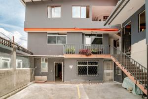 a large house with a staircase in a parking lot at Downtown Apartment, Sierra Nevada 3 in Ibarra