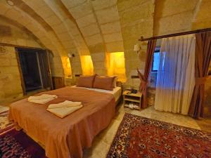 a bedroom with a bed with towels on it at Süleyman Cappadocia - Hot Air Balloon View in Göreme