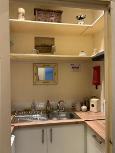 a kitchen with a sink and a counter top at Beautiful town-flat with character - Bridge street in Hereford +14 photos