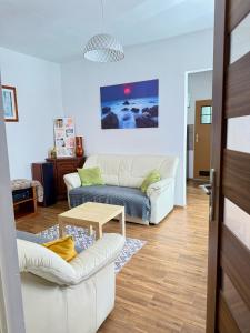 a living room with two couches and a table at Chata Białobrzeg in Białobrzeg Dalszy