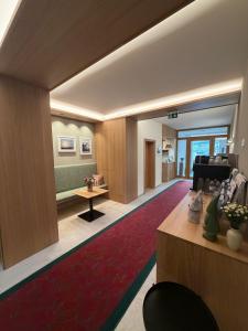 a living room with a red rug and a couch at Soldanella in Lech am Arlberg
