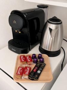 a cutting board with some food and a coffee maker at Bright Studio Near Paris & Disneyland in Neuilly-Plaisance