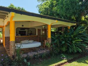 a bed under a pavilion in a garden at Los Tecales Hostal in Santa Catalina