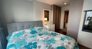a bedroom with a bed with a blue and white blanket at Hotel Luxe Elite in Chhatikara