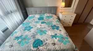 a bed with a blue and white comforter and a dresser at Hotel Luxe Elite in Chhatikara