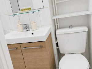 a bathroom with a white toilet and a sink at Bright Studio Near Paris & Disneyland in Neuilly-Plaisance +8 photos