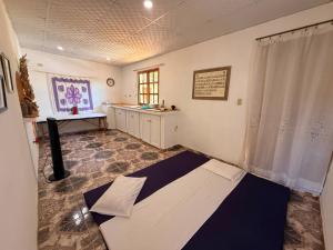 a room with a bed in the middle of a room at Los Tecales Hostal in Santa Catalina