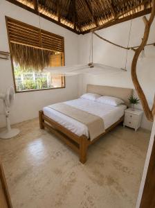 a bedroom with a bed and a window at la casablanca moñitos in Moñitos
