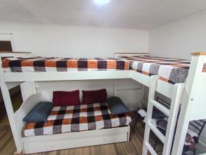 a bedroom with two bunk beds and a ladder at Monoambiente chico in Miramar