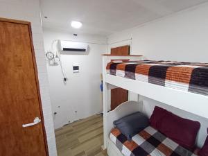 a room with two bunk beds and a door at Monoambiente chico in Miramar