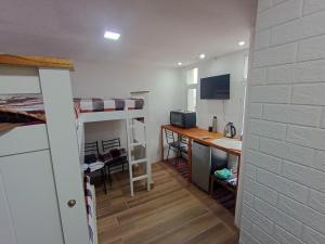 a dorm room with a desk and a computer in it at Monoambiente chico in Miramar