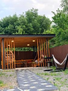 a gazebo with a table and two chairs at Cottage Orion in Sakramulo