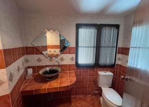 a bathroom with a toilet and a sink and a mirror at Hotel Park Star Premium Rooms in Tājganj