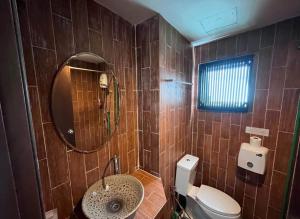 a bathroom with a sink and a toilet and a mirror at Hotel Park Star Premium Rooms in Tājganj