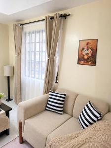 a living room with a couch and a window at Faymu Homes in Kitengela  +8 photos