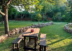 a wooden picnic table with a ball on top of it at Podere Cafasso Country House in Paestum +9 photos