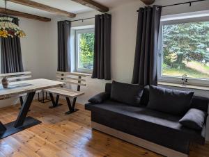 a living room with a couch and a table at Ferienunterkunft Woidwärts in Schwarzach