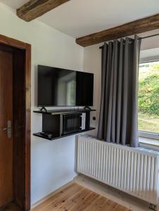 a living room with a tv and a window at Ferienunterkunft Woidwärts in Schwarzach +33 photos
