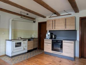 a kitchen with white appliances and wooden cabinets at Ferienunterkunft Woidwärts in Schwarzach