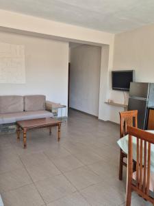 a living room with a couch and a table at Kohil Guest House in Ksamil