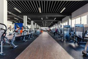 a gym with lots of treadmills and machines at Hinterhaus am Schloss Karlsruhe in Karlsruhe